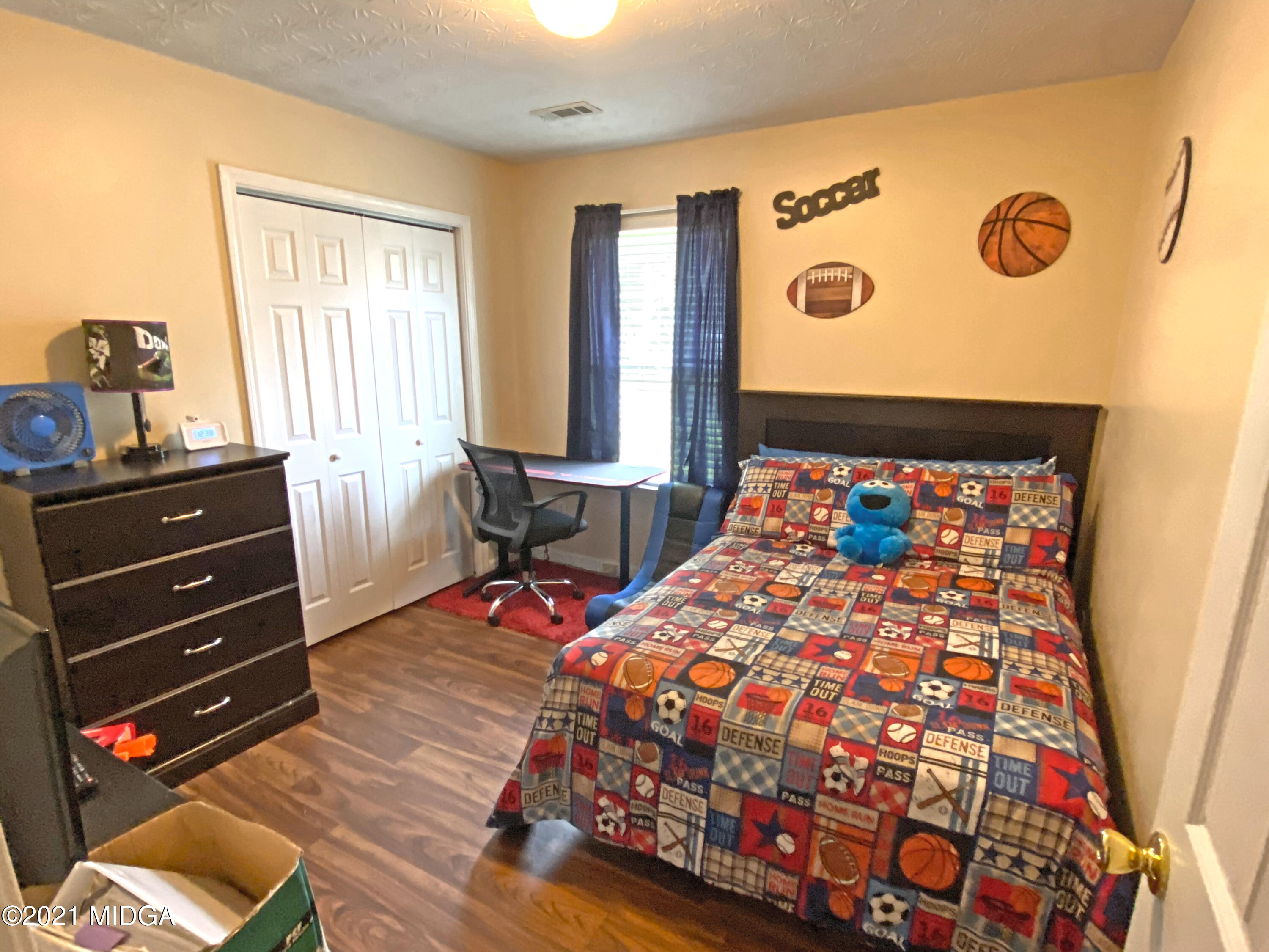 167 Apple Valley Road Macon, GA 31217 - Photo 8 of 25 a bedroom with a bed and wooden floor
