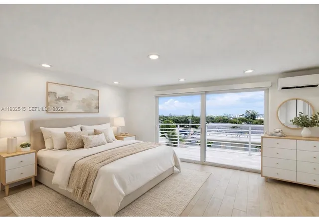 a bedroom with a large bed and a view of kitchen