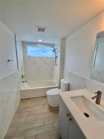 a bathroom with a sink a toilet and a bathtub