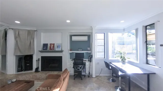 a view of a workspace with furniture and a window