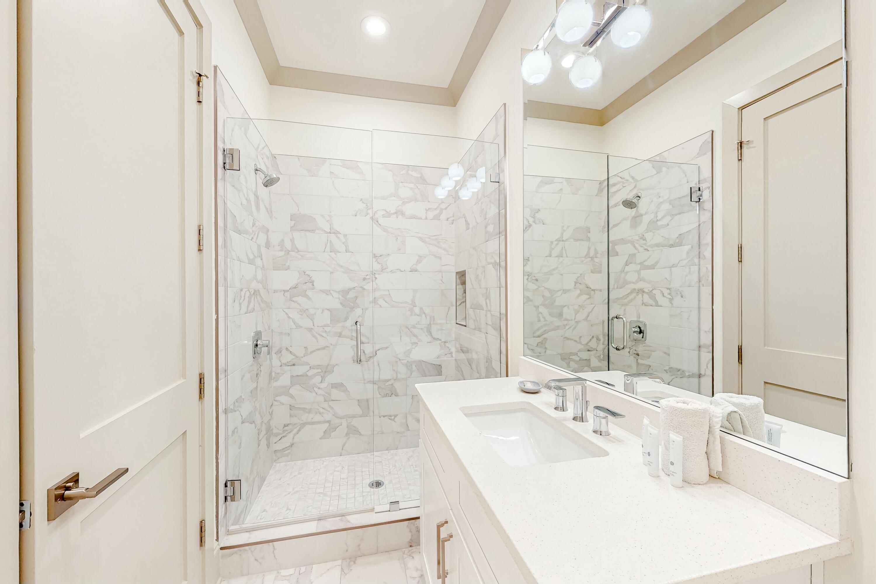 70 Marthas Lane, Unit 2201 Santa Rosa Beach, FL 32459 - Photo 11 of 28 a bathroom with a bathtub shower sink vanity and mirror