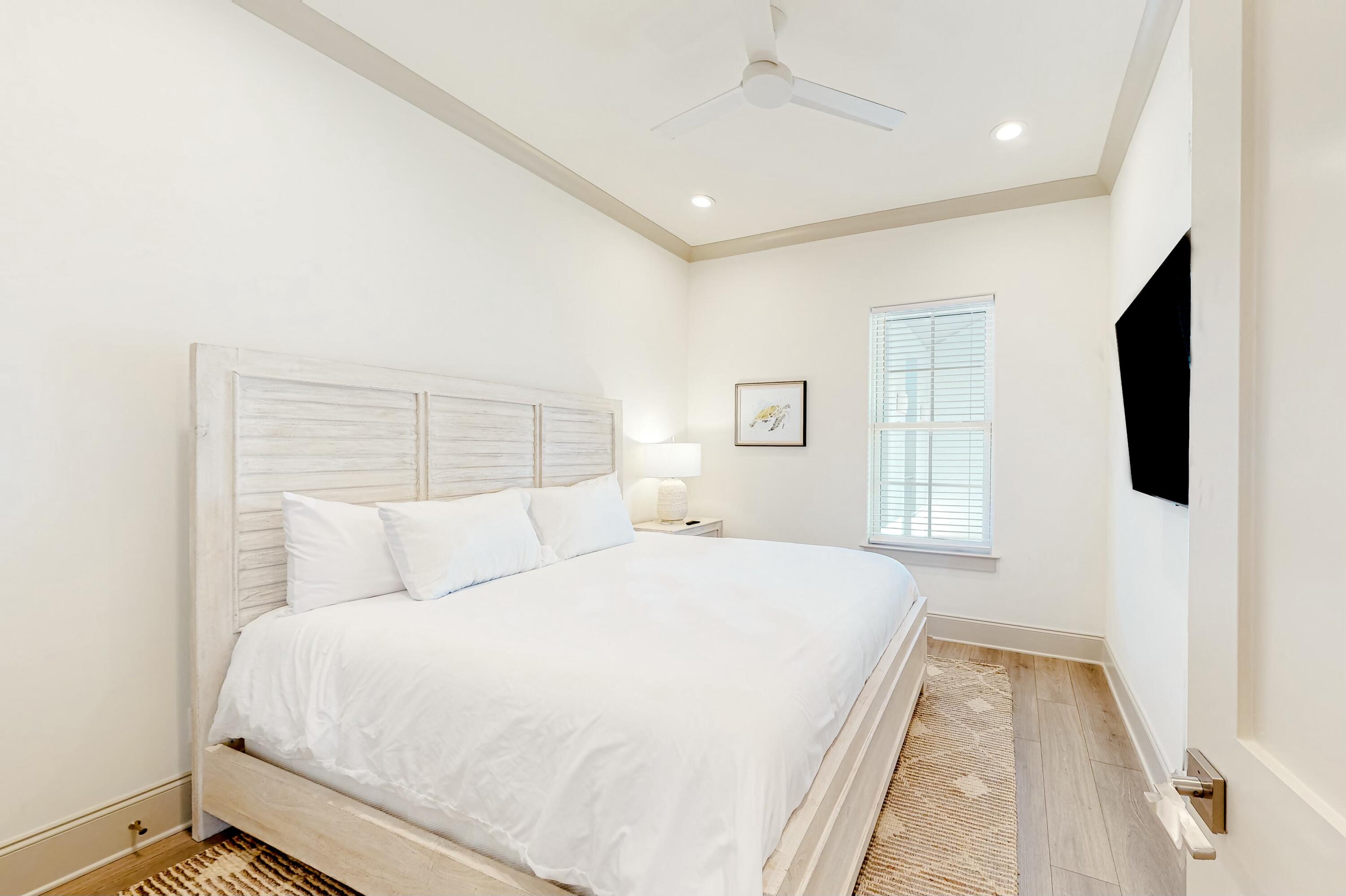 70 Marthas Lane, Unit 2201 Santa Rosa Beach, FL 32459 - Photo 12 of 28 a bedroom with a large bed and a flat tv screen on dresser