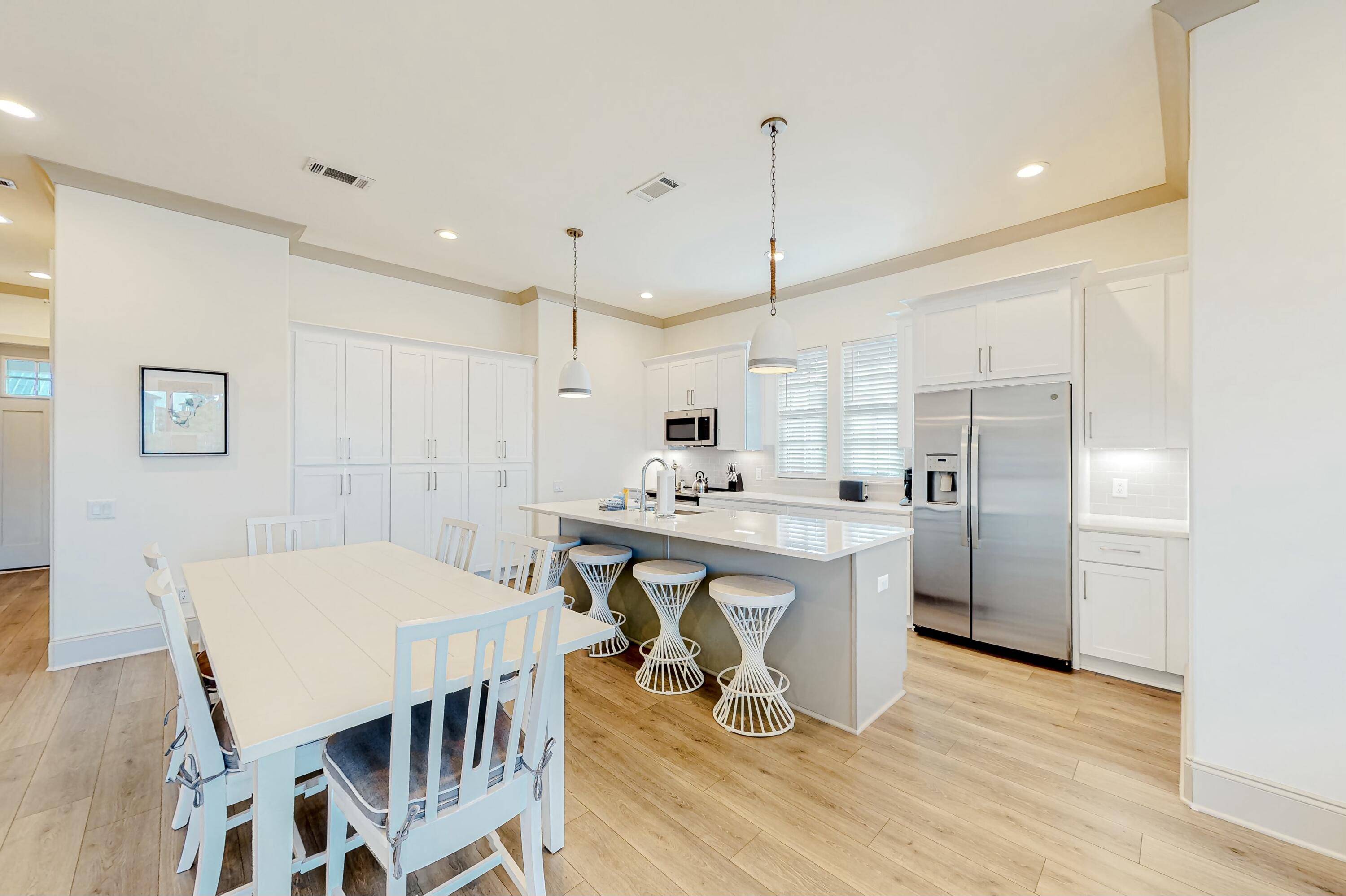 70 Marthas Lane, Unit 2201 Santa Rosa Beach, FL 32459 - Photo 4 of 28 a kitchen with stainless steel appliances a dining table chairs and wooden floor