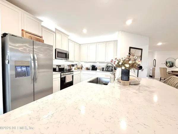 a kitchen with a refrigerator and a sink