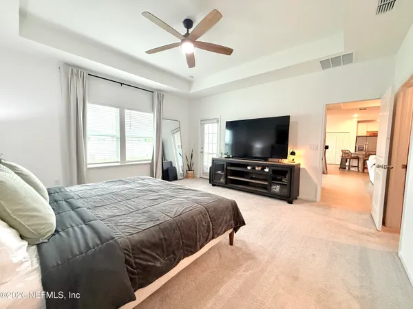 a bedroom with a bed and a flat screen tv