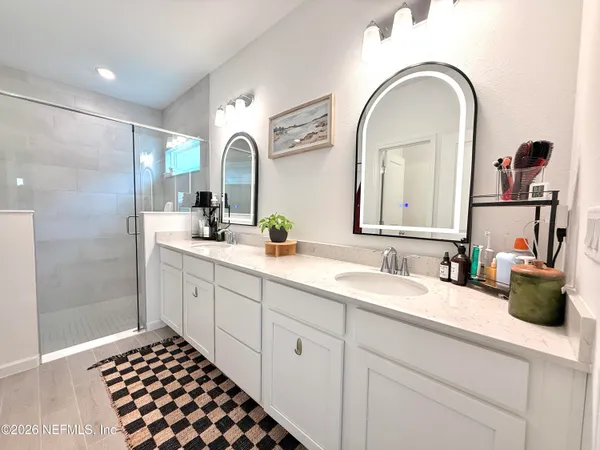 a bathroom with a double vanity sink and a mirror