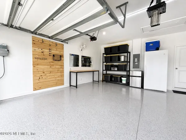 a view of an empty room with furniture and storage