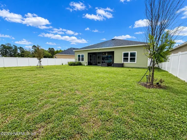 a view of a house with a backyard