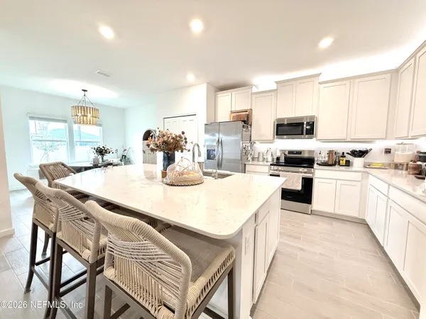 a kitchen with stainless steel appliances kitchen island granite countertop a sink and cabinets