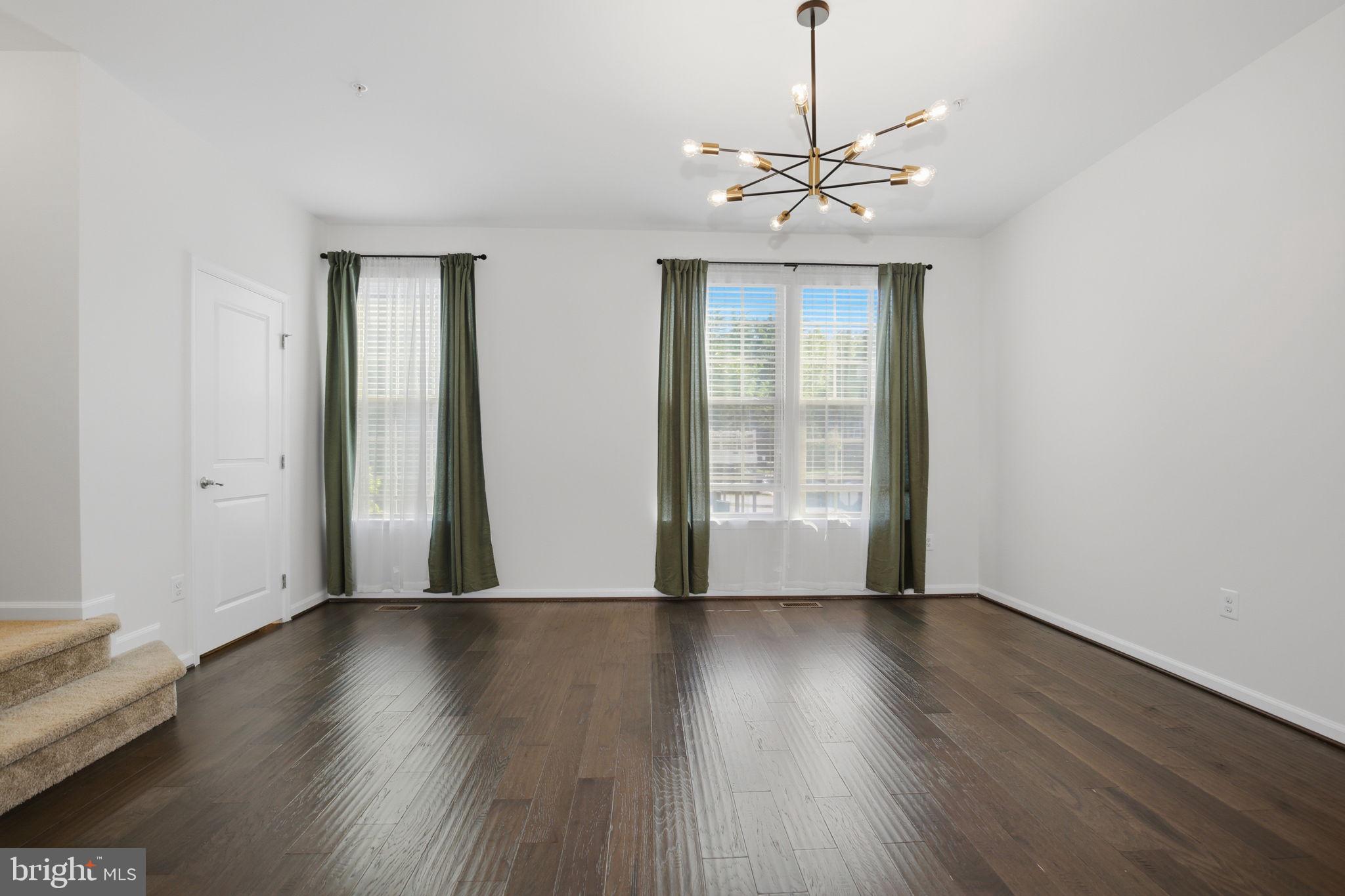 2784 Fredericksburg Road Hanover, MD 21076 - Photo 24 of 60 a view of a livingroom with wooden floor and a ceiling fan