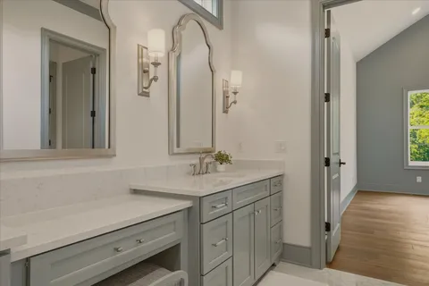 a bathroom with a sink vanity and a mirror