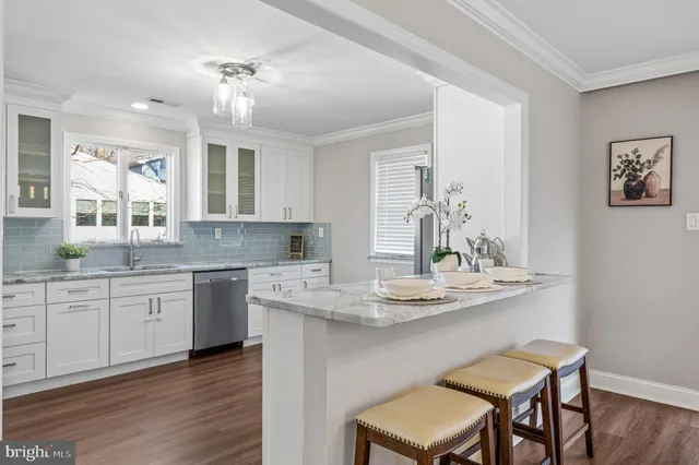 a kitchen with sink dining table and chairs