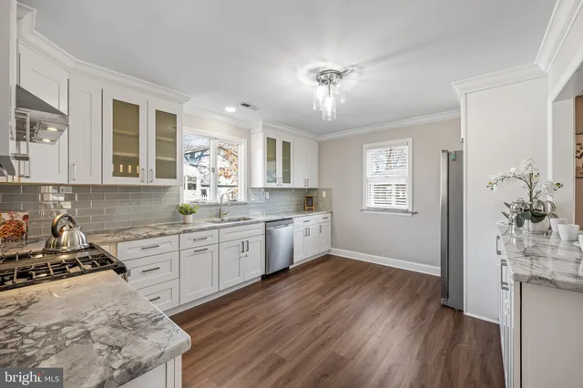 a kitchen with a white cabinets counter top space and a window