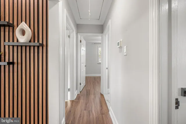a view of a hallway with wooden floor