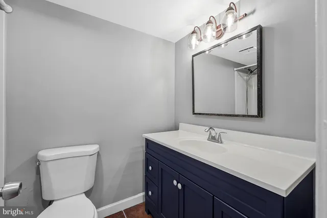 a bathroom with a toilet sink and mirror