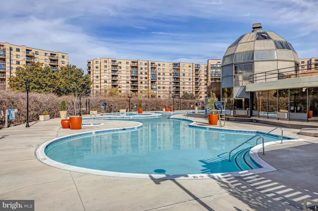 a view of a swimming pool with outdoor seating