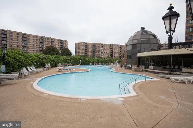 a swimming pool with outdoor seating and yard