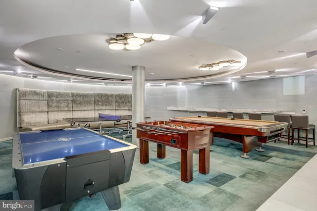 a view of backyard with table and chairs and potted plants