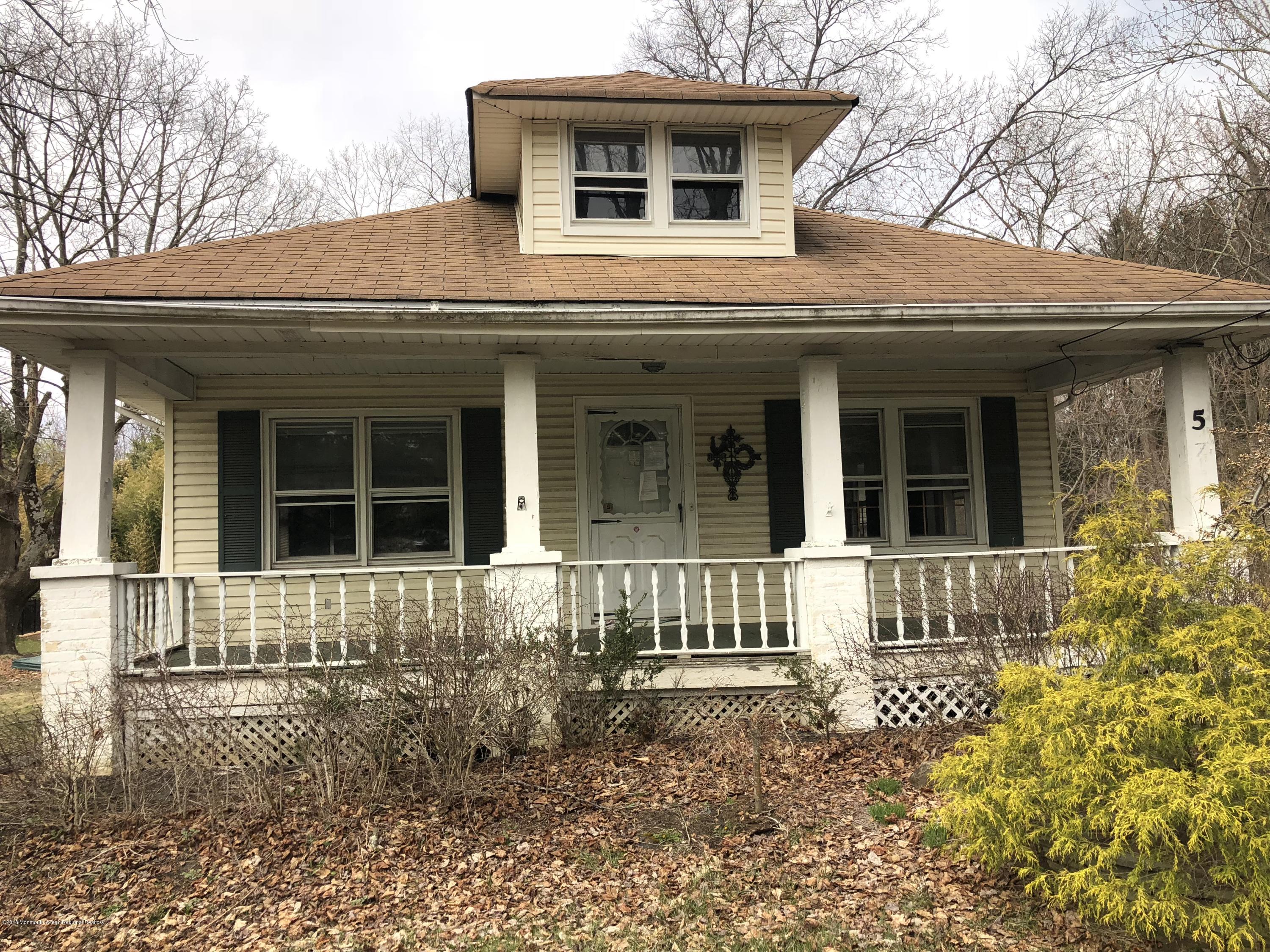 571 Craig Road Manalapan, NJ 07726 - Photo 6 of 6 a front view of a house with a garden