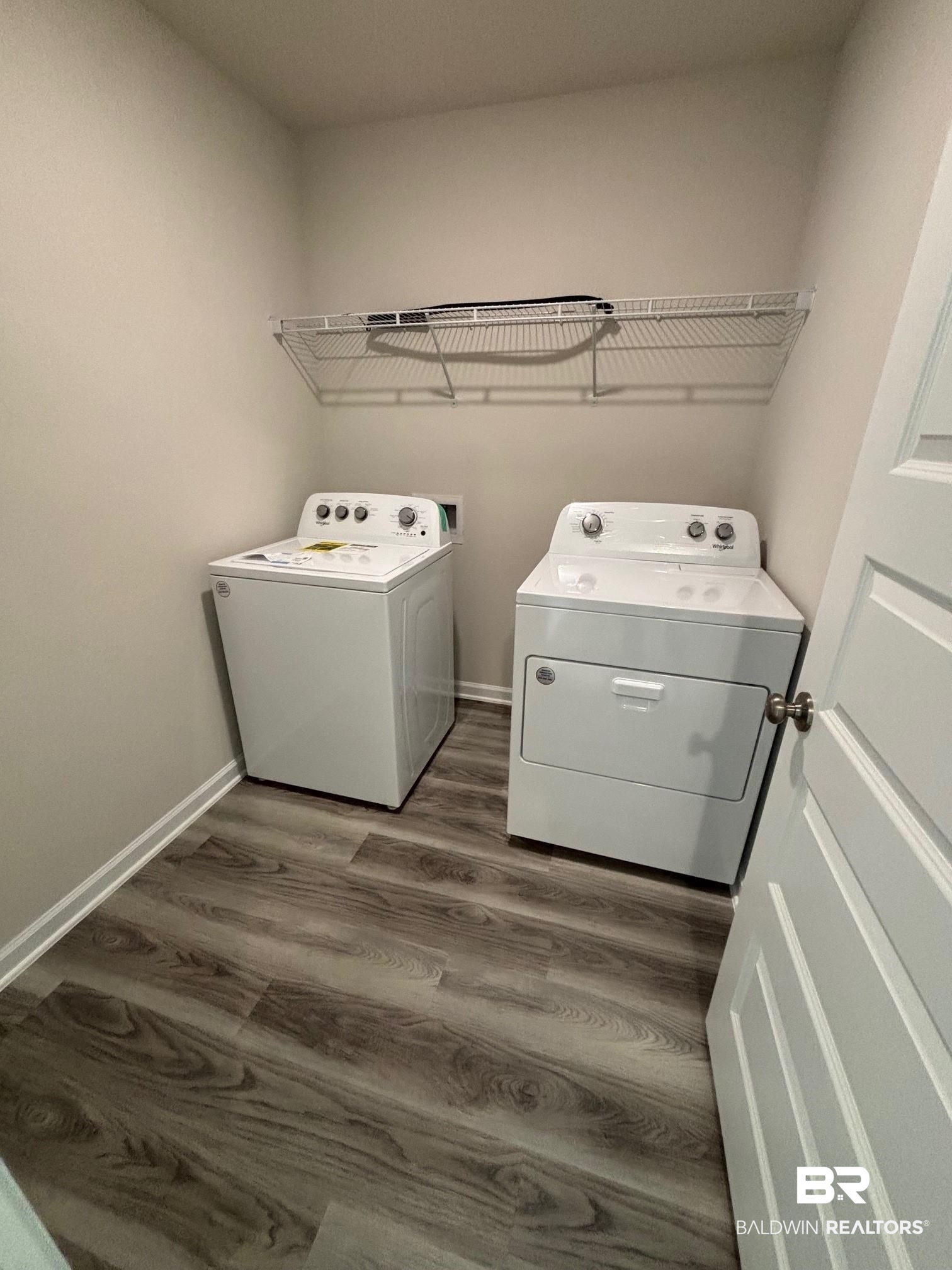 22215 Aleutian Avenue Foley, AL 36535 - Photo 16 of 34 Laundry room with washer and clothes dryer and dark wood-type flooring