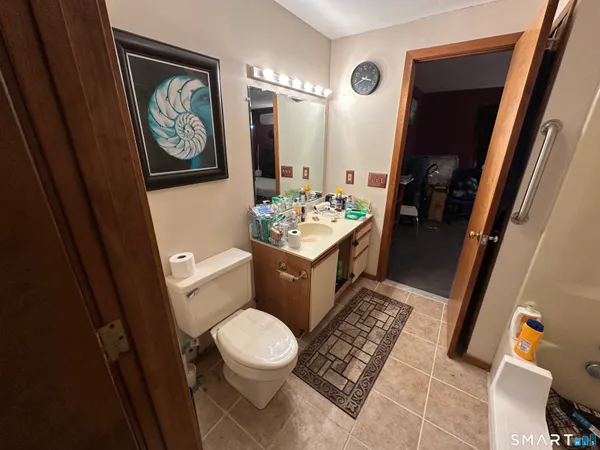 a bathroom with a toilet a sink and a mirror