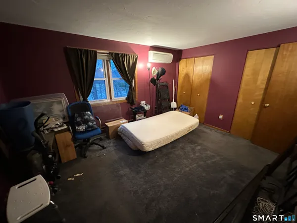 a bedroom with a bed and a mirror