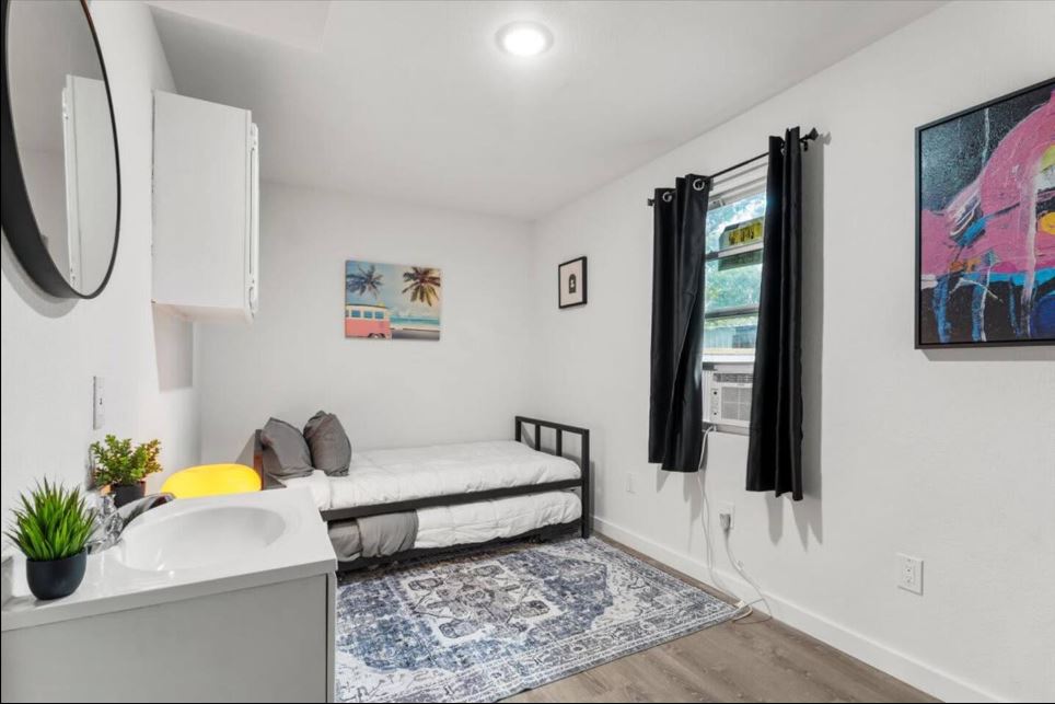 1100 Neans Drive Austin, TX 78758 - Photo 15 of 40 Bedroom with light wood-style floors and cooling unit