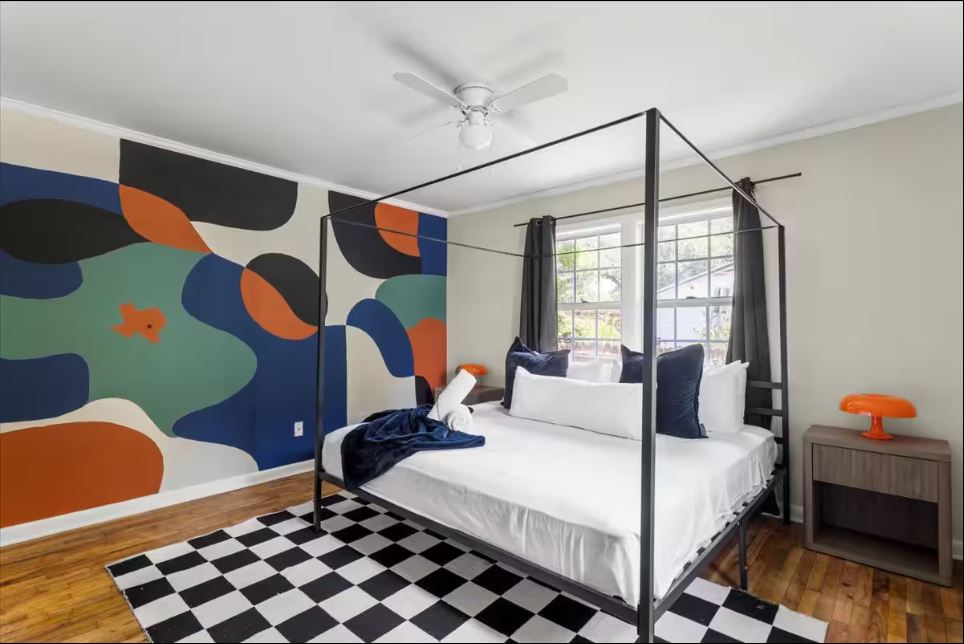 1100 Neans Drive Austin, TX 78758 - Photo 17 of 40 Bedroom with wood finished floors, ornamental molding, ceiling fan, and an accent wall