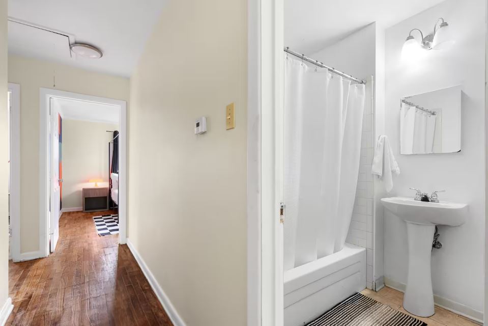 1100 Neans Drive Austin, TX 78758 - Photo 20 of 40 Bathroom with shower / bath combo with shower curtain and light wood-style flooring