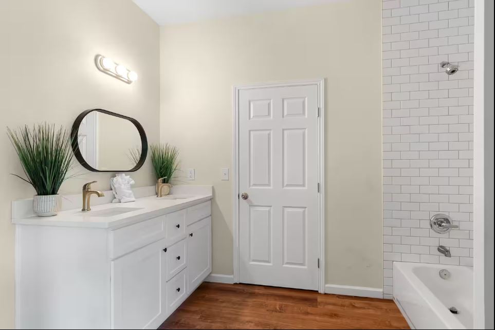 1100 Neans Drive Austin, TX 78758 - Photo 26 of 40 Bathroom featuring double vanity, shower / tub combination, and dark wood-style floors