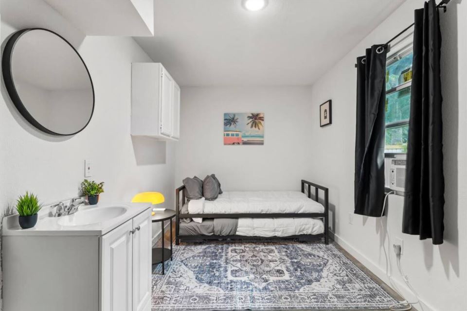 1100 Neans Drive Austin, TX 78758 - Photo 32 of 40 Bedroom with baseboards and a sink