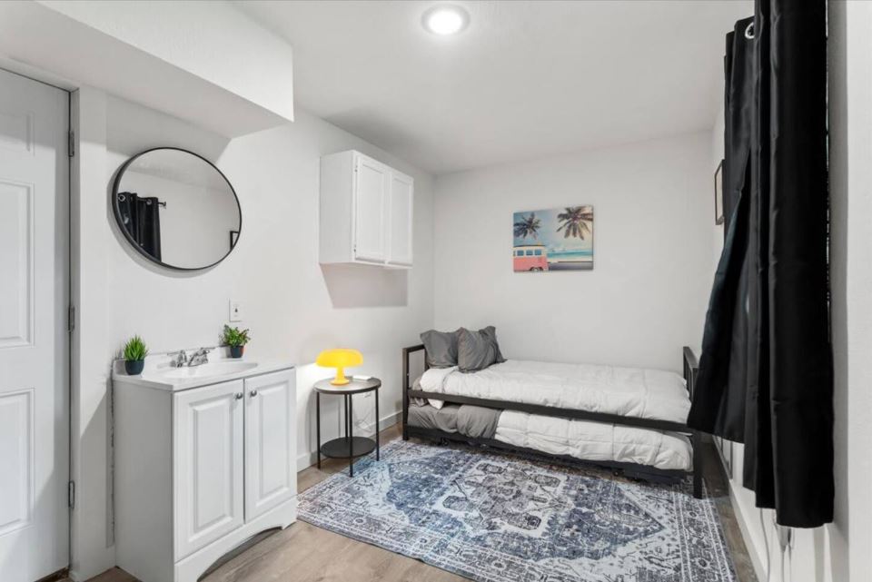 1100 Neans Drive Austin, TX 78758 - Photo 34 of 40 Bedroom with light wood-type flooring and baseboards