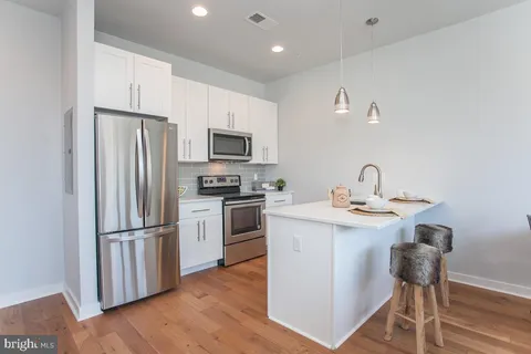 a kitchen with a refrigerator a sink and a stove