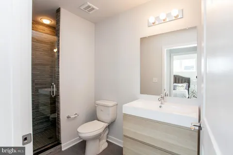 a bathroom with a sink toilet and shower
