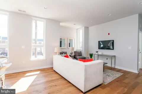 a living room with dining room and flat screen tv