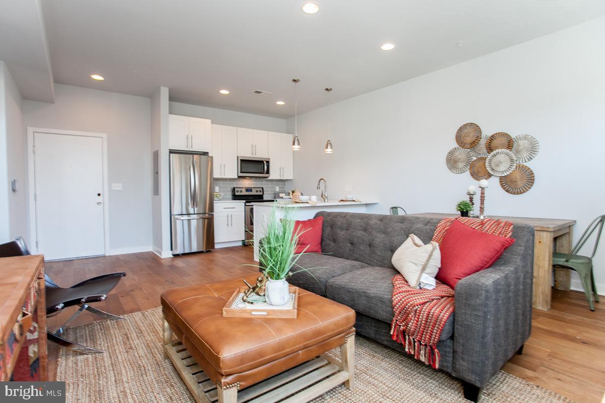 5938 Henry Avenue, Unit 1 Philadelphia, PA 19128 - Photo 9 of 19 a living room with furniture and kitchen view