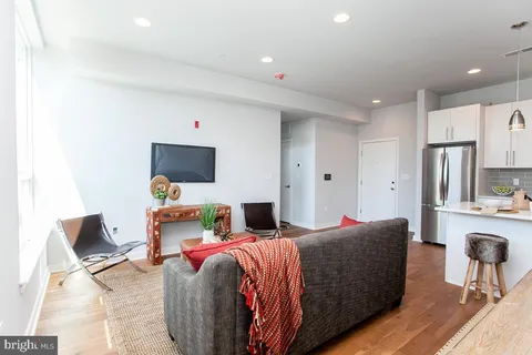 a bed room with a bed and a television