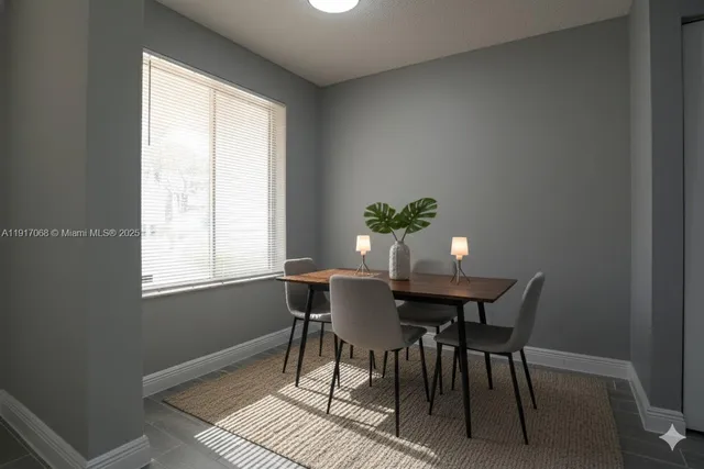 a view of a dining room with furniture and window