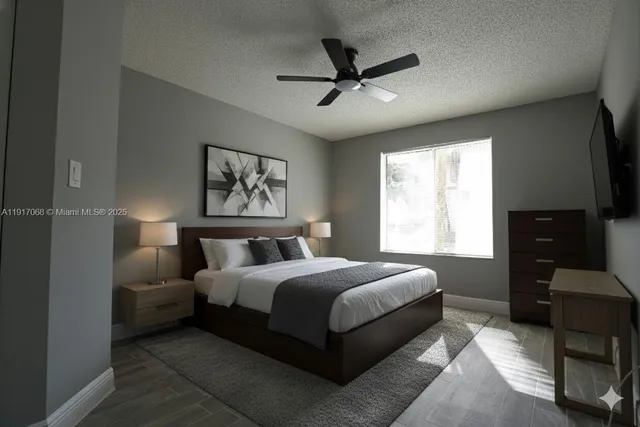 a bedroom with a bed a couch and a window