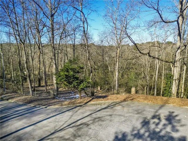 a view of a park with iron fence
