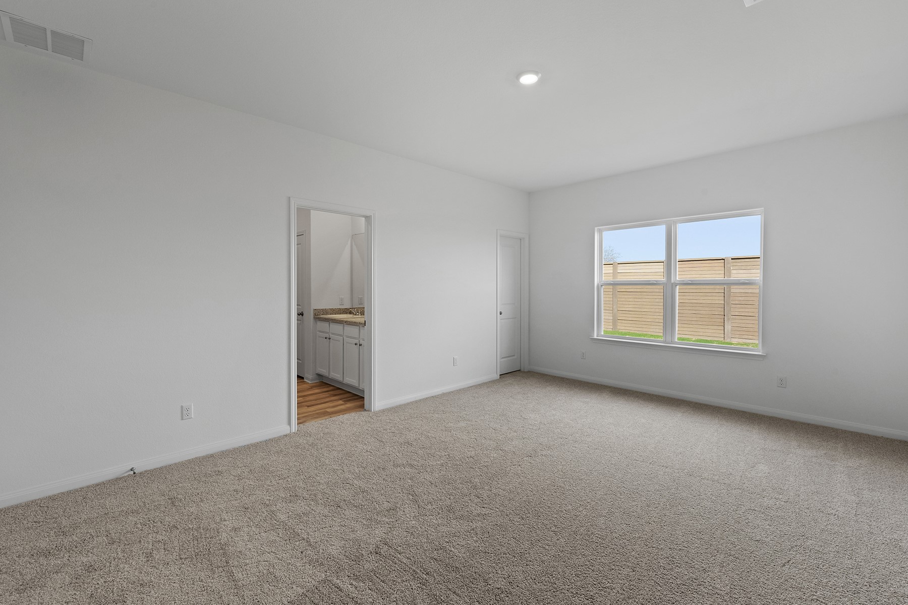 14617 Wahlbergs Way Elgin, TX 78621 - Photo 4 of 11 Peace and privacy await you in the master suite. this luxurious retreat offers an incredible amount of space, serene backyard views and a spa-like master bath.