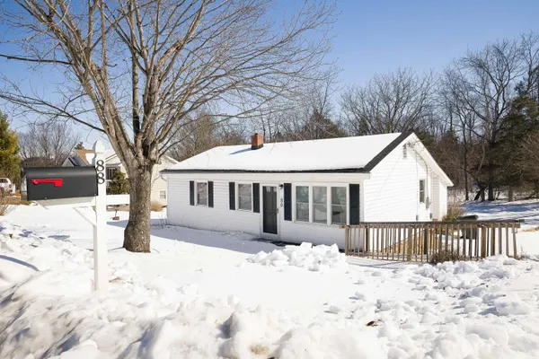 a view of a house with snow on the road