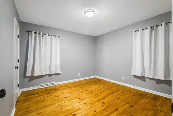 a view of a room with wooden floor