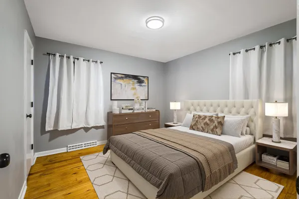 a bedroom with double bed and a couch