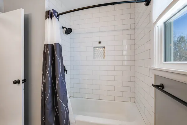 a bathroom with a shower and a bathtub