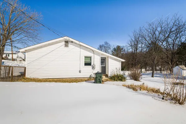 a view of a house with snow on the road