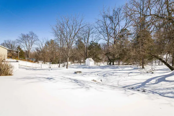 a view of a yard with snow on the road