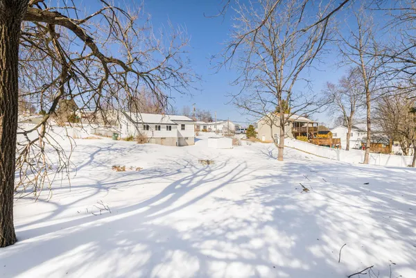 a view of a yard covered in snow