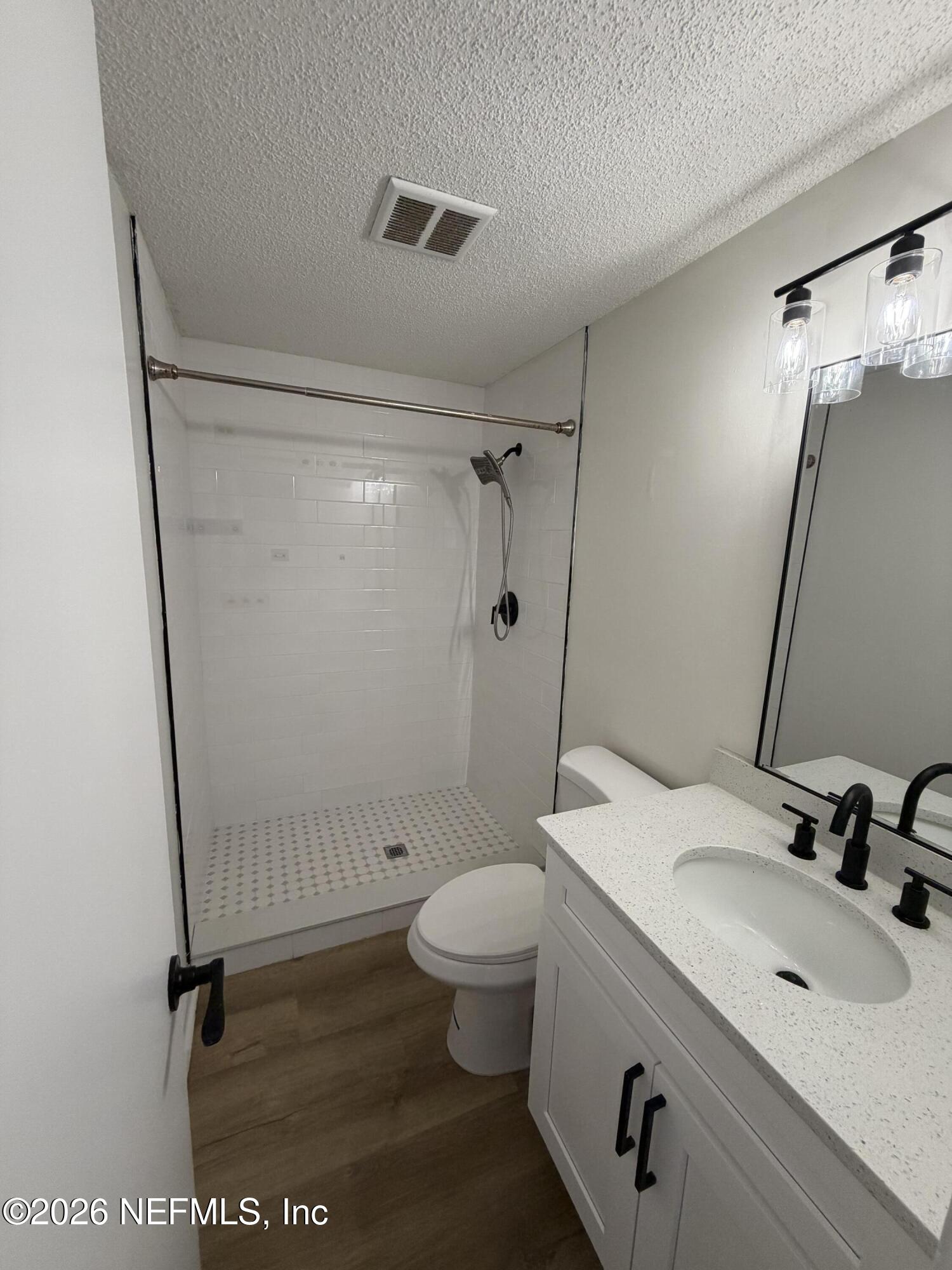 7539 Walden Road Jacksonville, FL 32244 - Photo 9 of 18 a bathroom with a sink a toilet and a large mirror