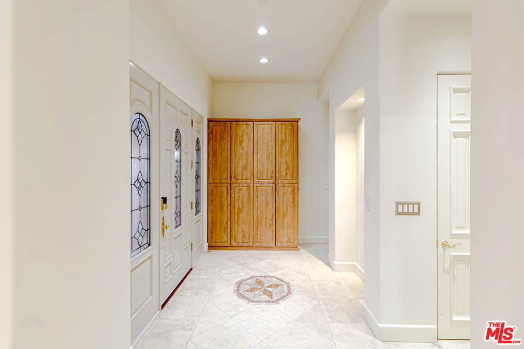 12626 Promontory Road Los Angeles, CA 90049 - Photo 11 of 34 a view of a hallway with windows